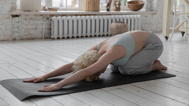 Woman doing yoga child’s pose
